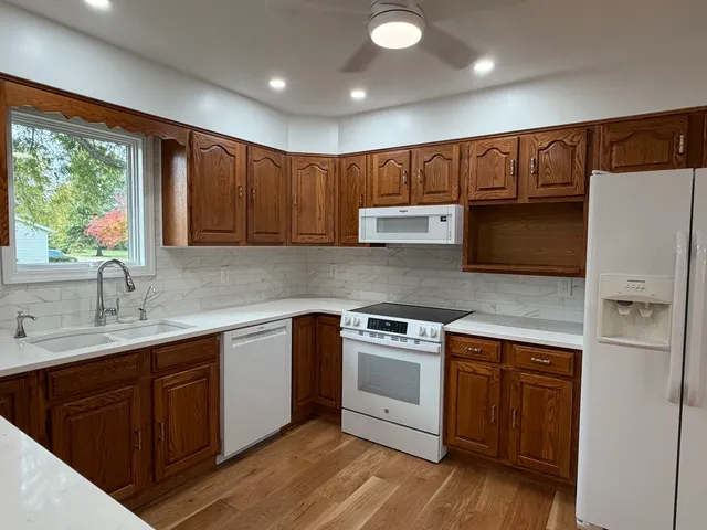 a kitchen with a sink a refrigerator and window