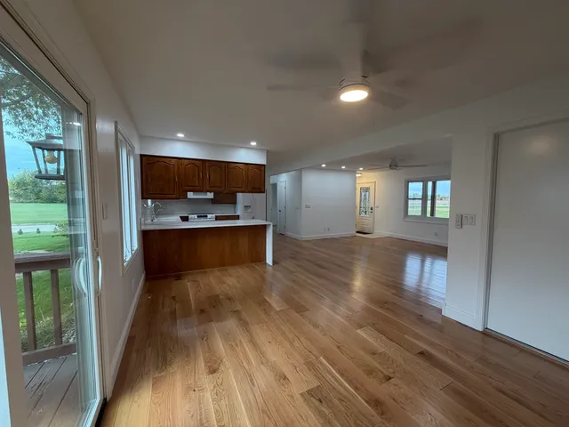 a view of kitchen and hall with wooden floor