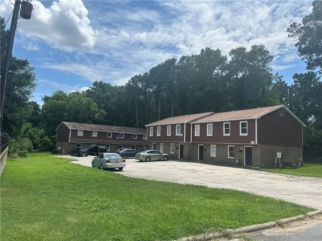 a front view of a house with a yard table and chairs