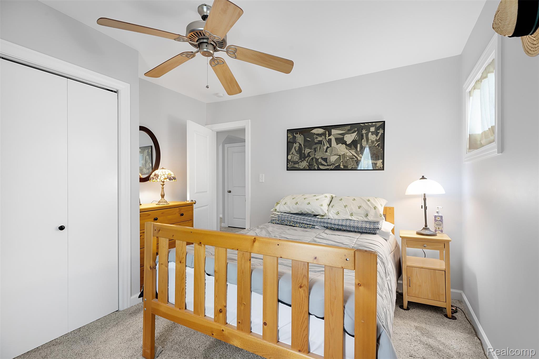 22827 Meridian Road Grosse Ile, MI 48138 - Photo 28 of 36 Bedroom featuring light carpet, a closet, and a ceiling fan