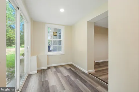 a view of a room with wooden floor and window