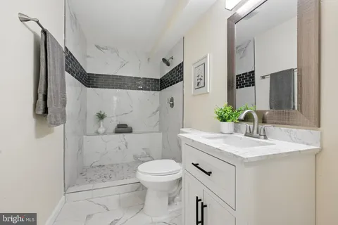 a bathroom with a sink toilet and shower