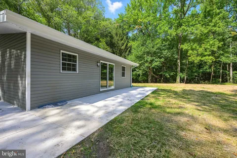 a view of a house with a yard and sitting area