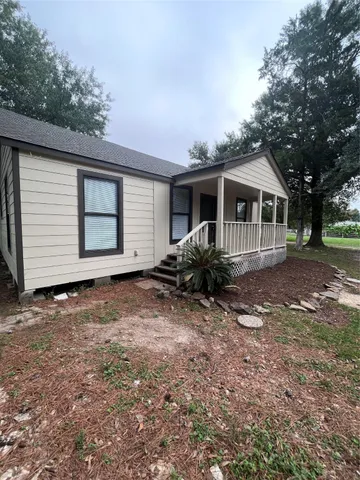 a front view of house with yard and trees