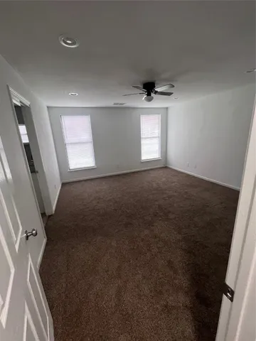 an empty room with windows and entrance