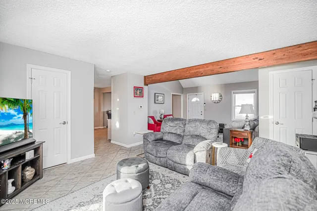 a kitchen with stainless steel appliances granite countertop a stove a sink dishwasher and a refrigerator with wooden floor