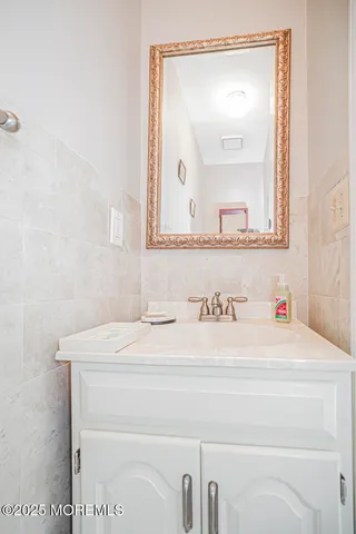 a kitchen with kitchen island granite countertop a sink appliances cabinets and counter space