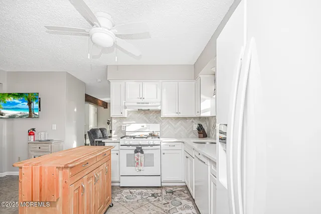 a bedroom with a bed mirror and window