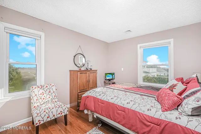 a bed sitting in a bedroom next to a window