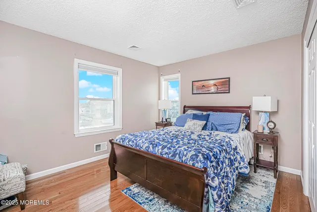 a bedroom with a bed and painting on the wall