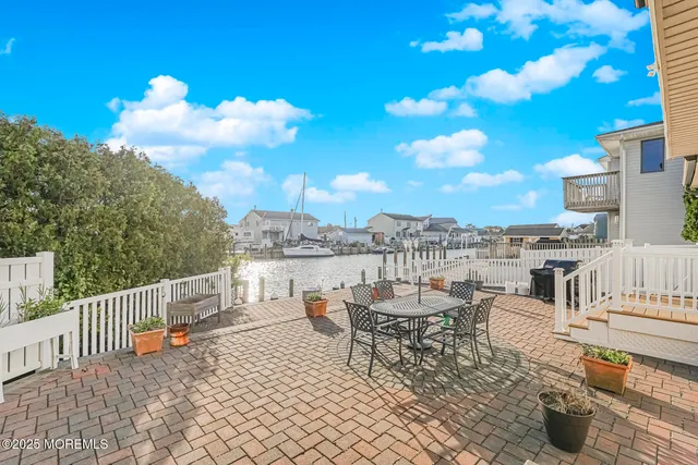 a view of a terrace with furniture and city view