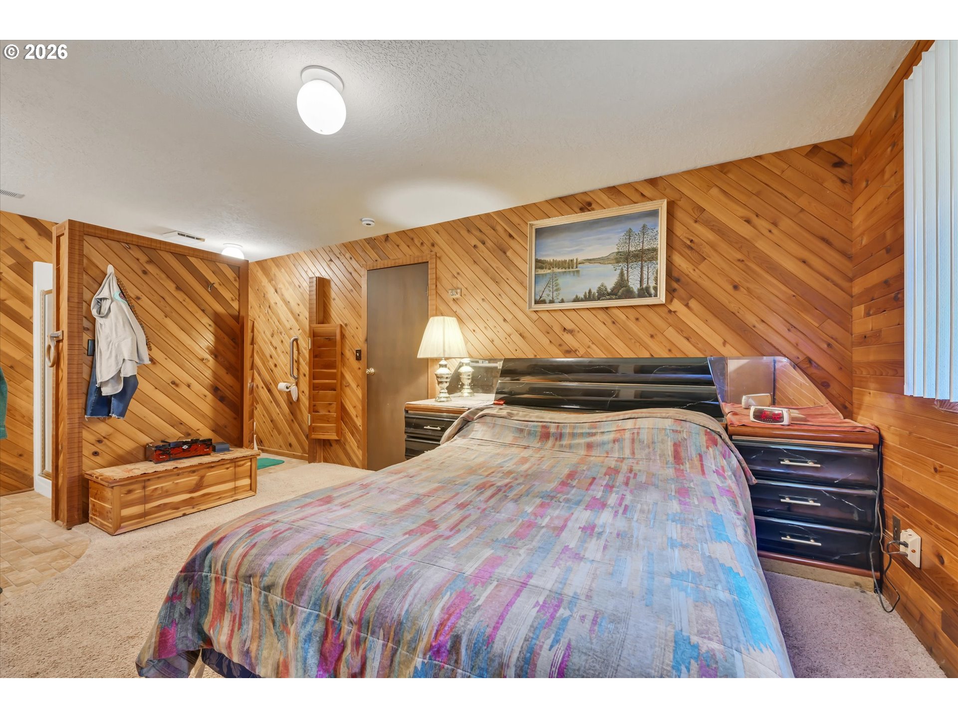 91 Godfrey Road Mossyrock, WA 98564 - Photo 23 of 47 a bedroom with a bed and wooden floor