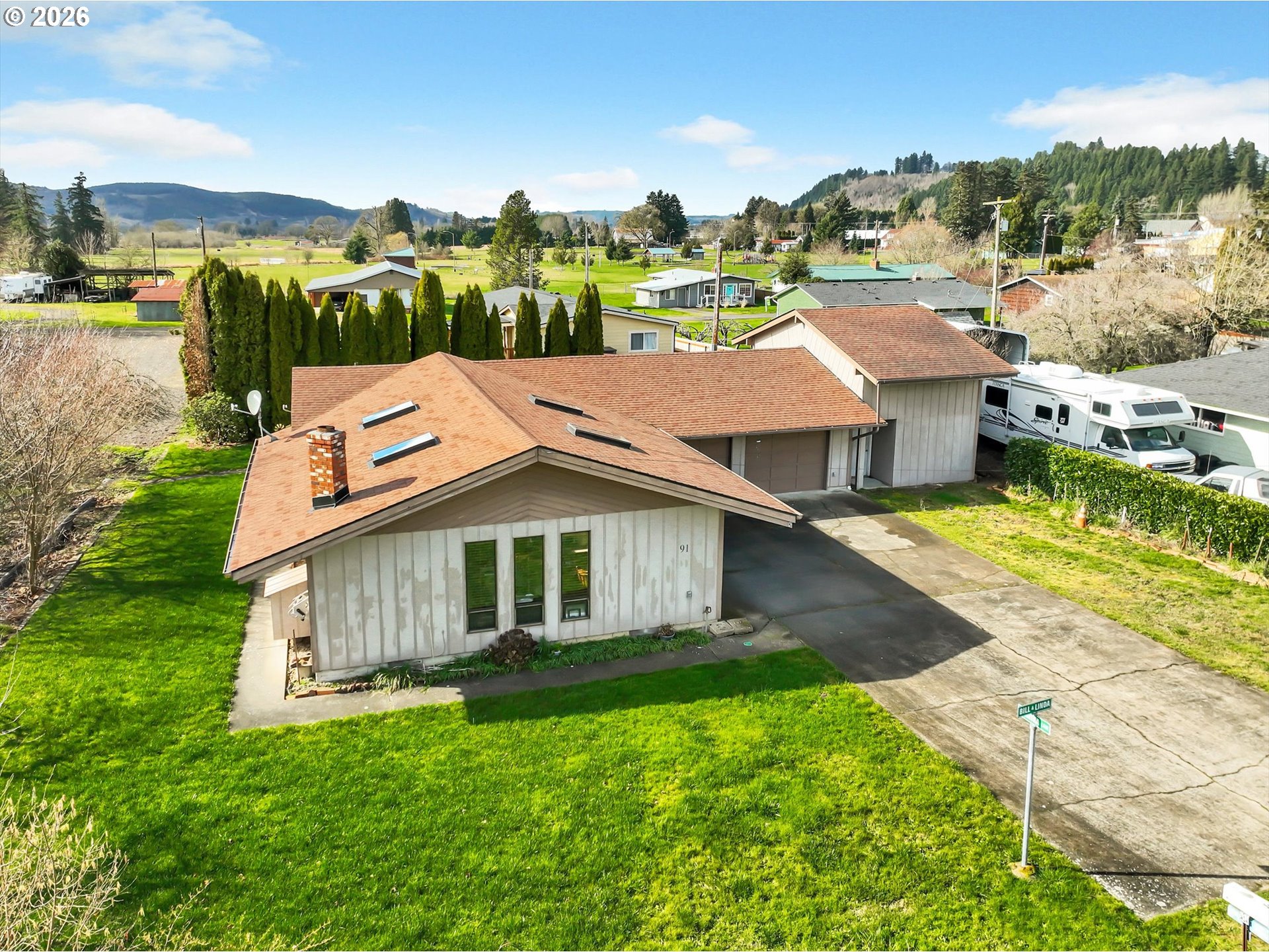 91 Godfrey Road Mossyrock, WA 98564 - Photo 39 of 47 a aerial view of a house with a yard table and chairs