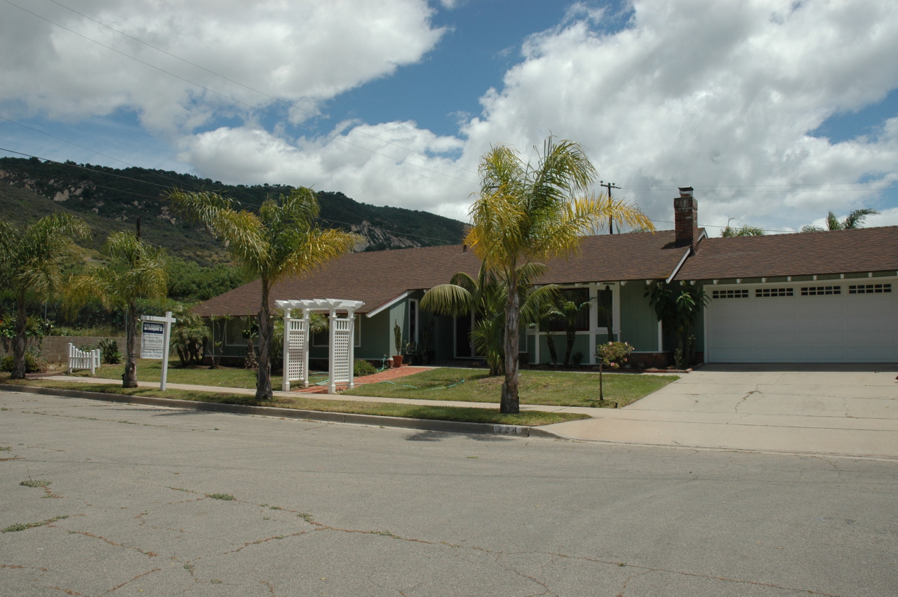 a backyard of a house with a sink and garden