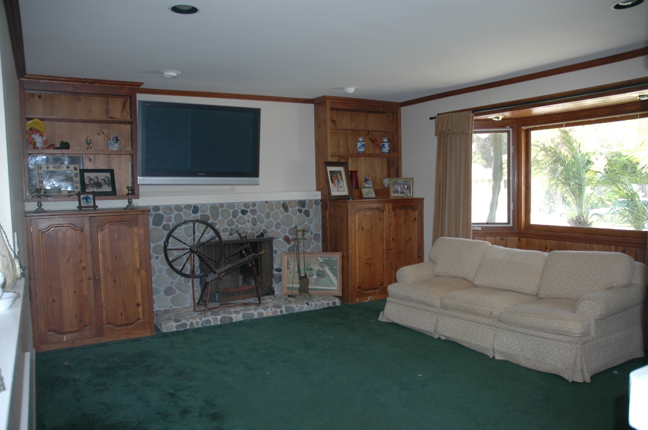 224 Serpolla Drive Carpinteria, CA 93013 - Photo 2 of 11 a living room with furniture a flat screen tv and a fireplace