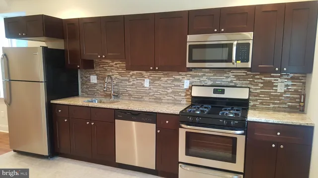a view of kitchen with a refrigerator cabinet and a microwave