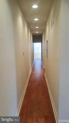 a view of kitchen with refrigerator and wooden floor