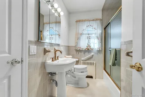 a bathroom with a sink mirror and shower