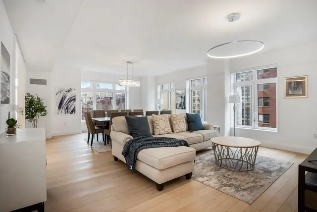 a view of a dining room with furniture wooden floor and chandelier