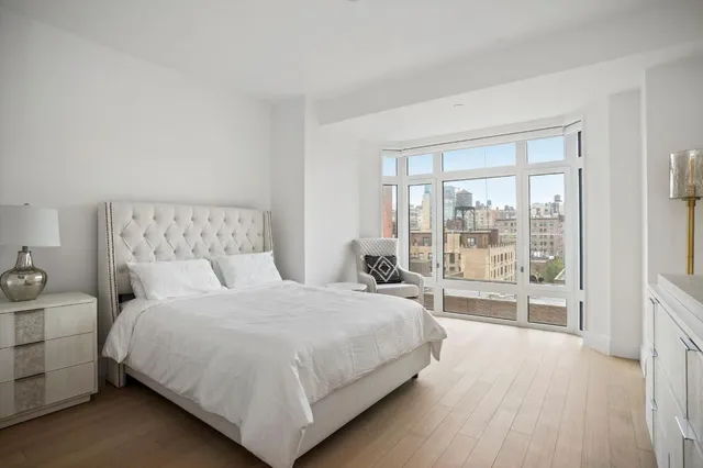 a bedroom with a large bed and a large window