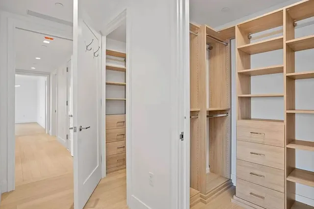 a bedroom with a bed couch and a large window