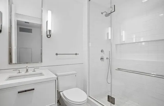 a bedroom with two beds and a large window