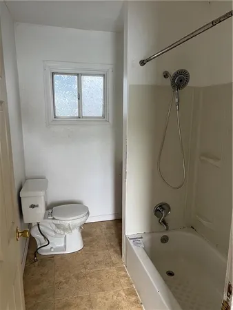 a bathroom with a toilet and a tub