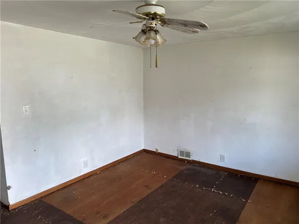 a view of a big room with a fan