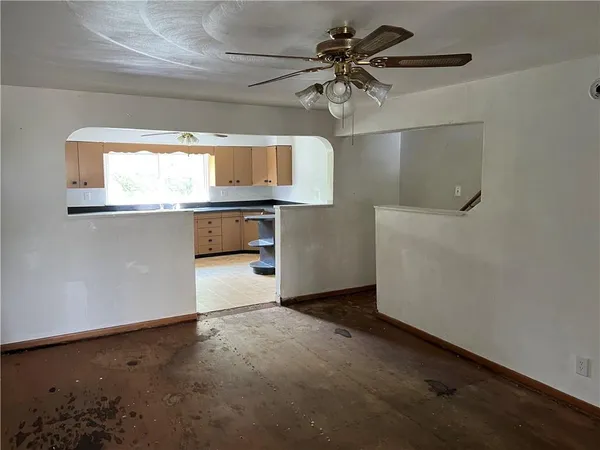 a kitchen with a stove a microwave and white cabinets