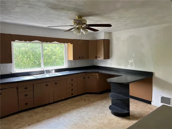 a kitchen with a sink and window