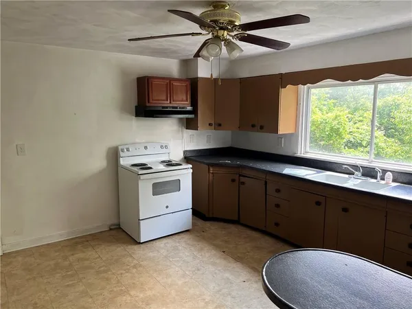 a kitchen with a sink cabinets and window