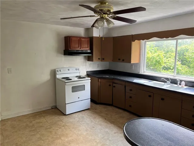 a kitchen with a sink cabinets and window