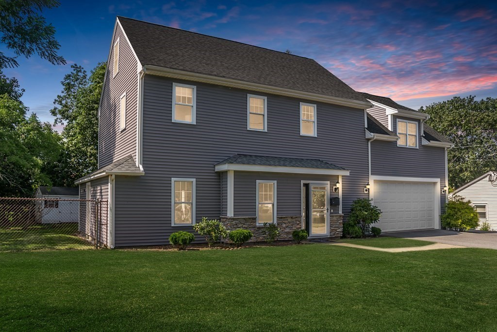 a front view of a house with a garden