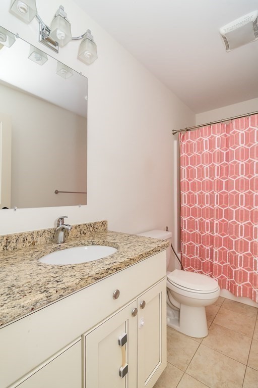 10 Farrant Road Natick, MA 01760 - Photo 15 of 31 a bathroom with a granite countertop sink a toilet and a mirror