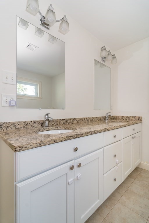 10 Farrant Road Natick, MA 01760 - Photo 19 of 31 a bathroom with a granite countertop double vanity sink and mirror