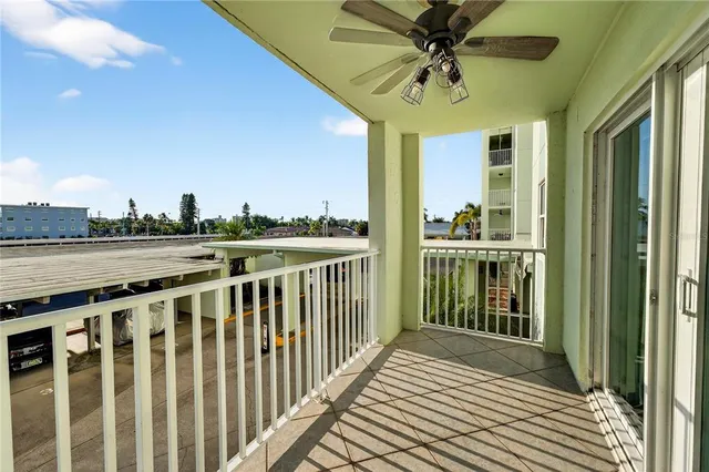 a view of a balcony with furniture and a floor to ceiling window