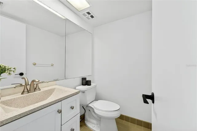 a bathroom with a sink toilet and vanity