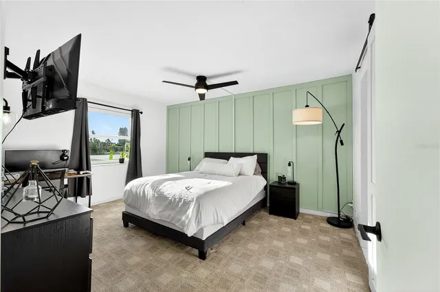 a spacious bedroom with a bed and large mirror