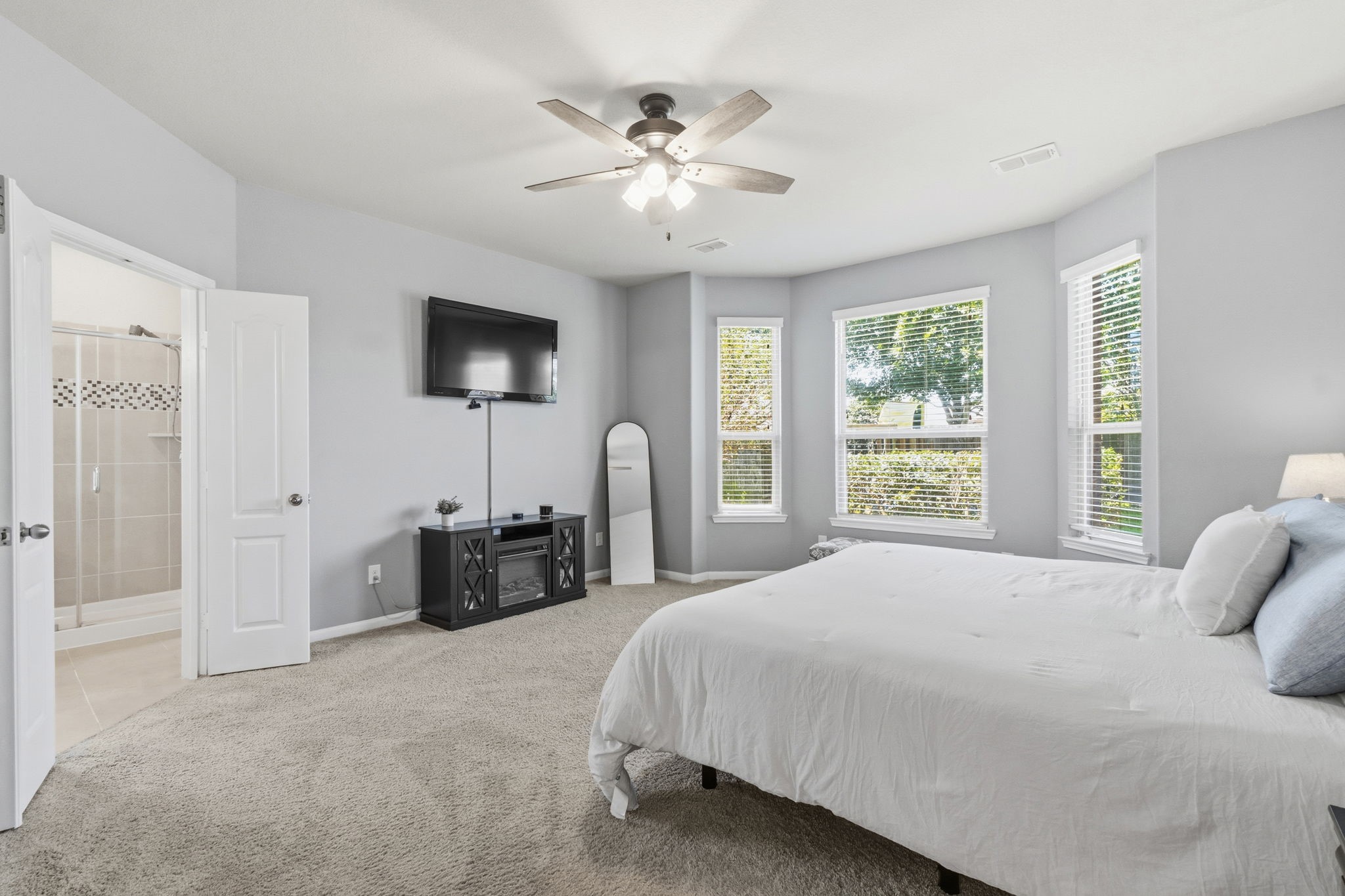 3900 Enchanted Timbers Lane Spring, TX 77386 - Photo 18 of 49 a bedroom with a bed and a chandelier