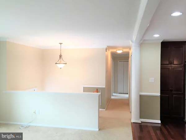 a view of a kitchen with a refrigerator and a sink
