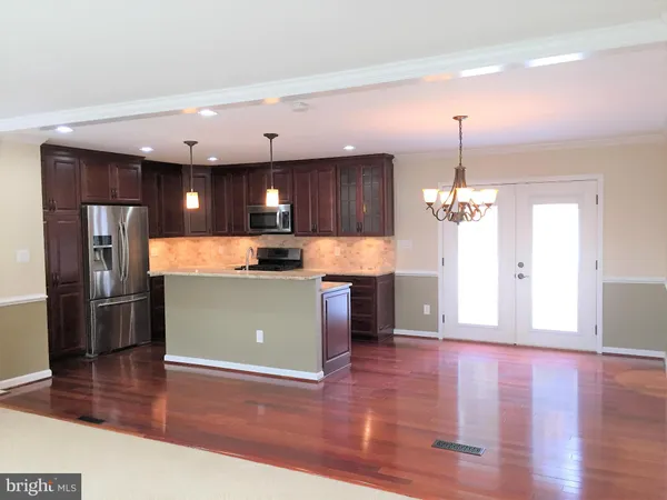 a view of kitchen with refrigerator and window