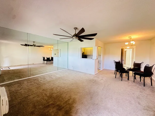 a view of a livingroom with furniture and a ceiling fan
