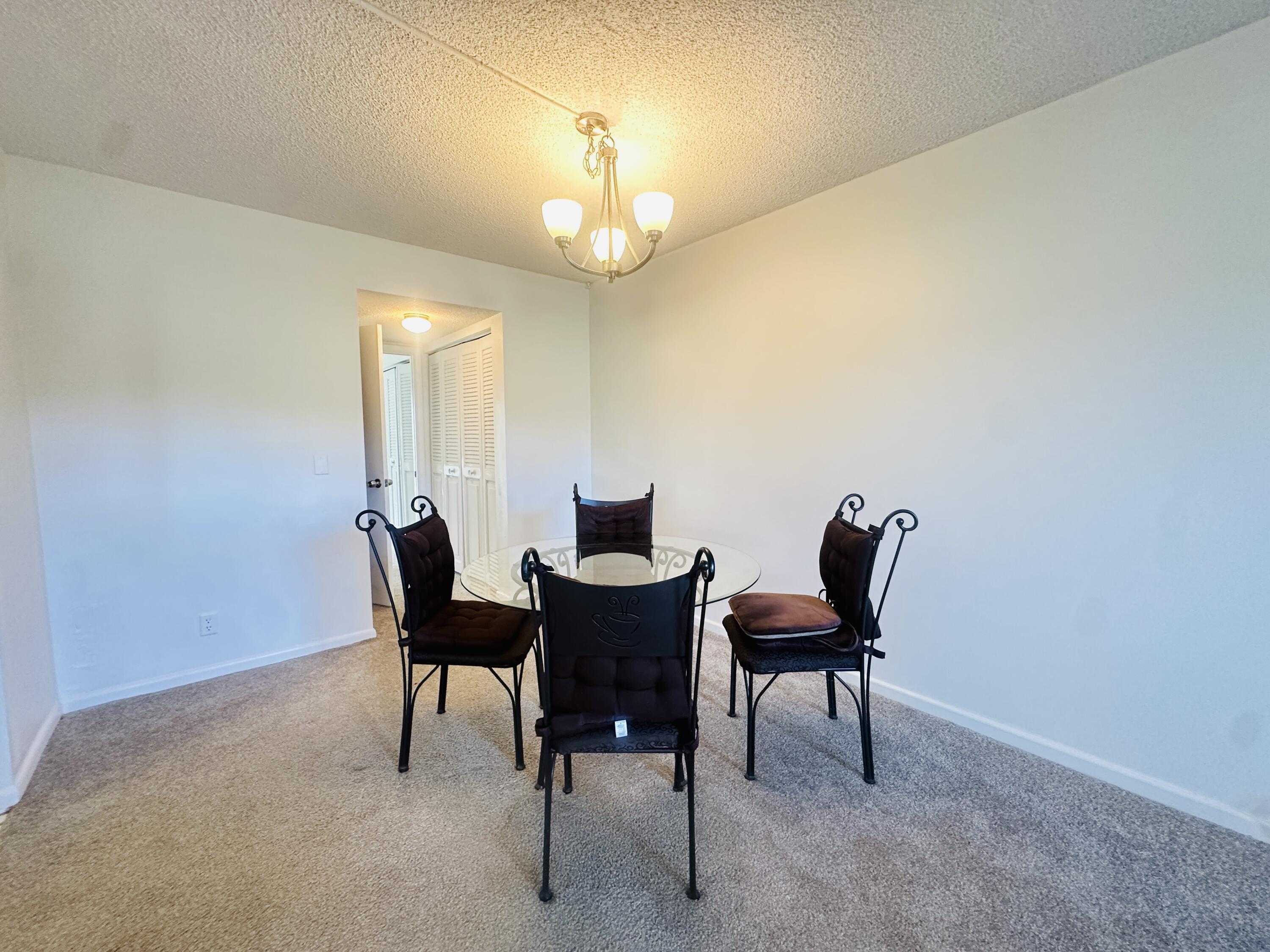 129 Brighton D Boca Raton, FL 33434 - Photo 5 of 11 a view of a dining room with furniture and a chandelier