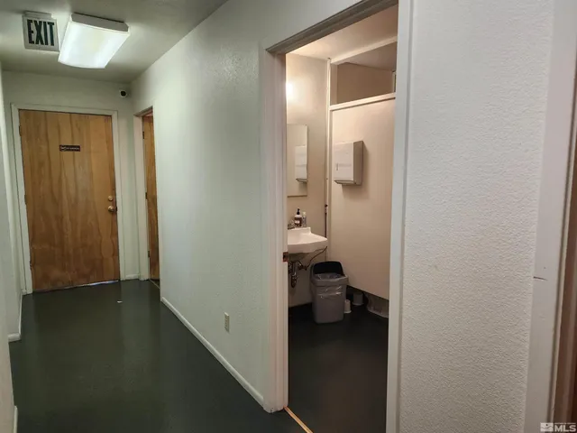 a view of a room with wooden floor and a window