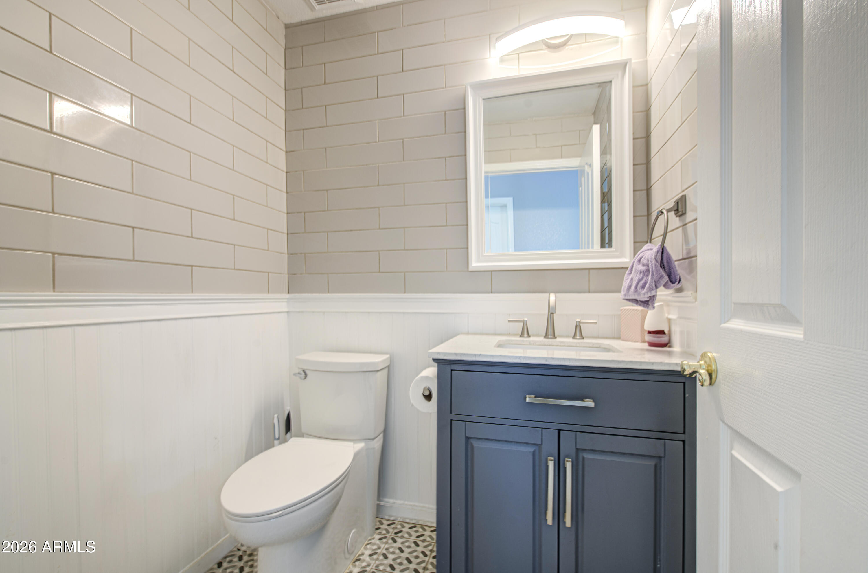 12403 West Monte Vista Road Avondale, AZ 85392 - Photo 46 of 63 a bathroom with a granite countertop toilet a sink and a mirror