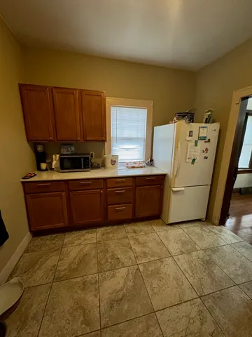 a kitchen with a cabinets and white appliances