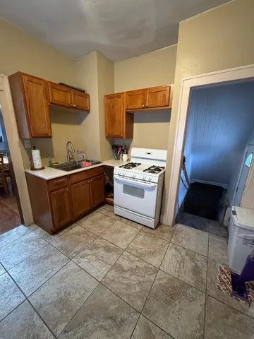 a kitchen with a stove sink and cabinets