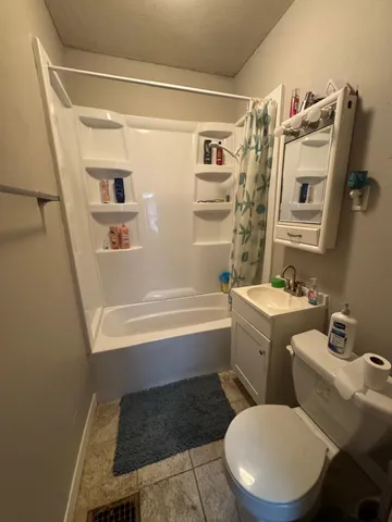 a bathroom with a toilet a sink and a bathtub