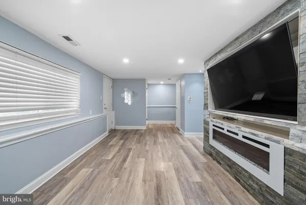 a view of a livingroom with wooden floor and flat screen tv