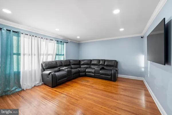 a living room with furniture window and a flat screen tv